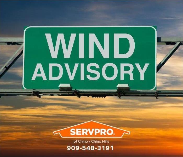 A “wind advisory” road sign is seen.
