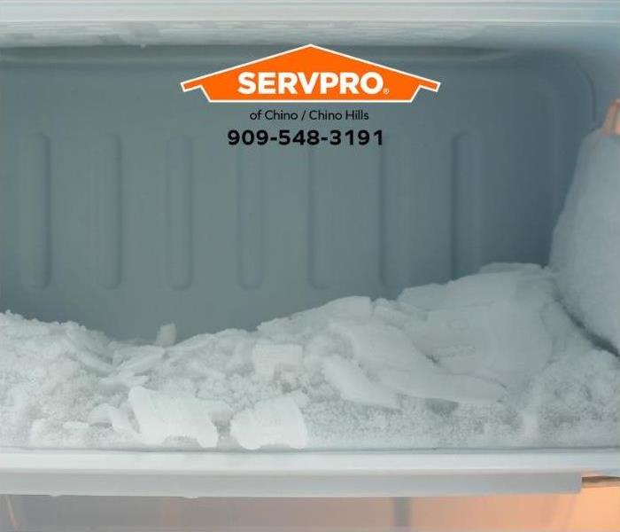 A refrigerator’s freezer is clogged with ice buildup.