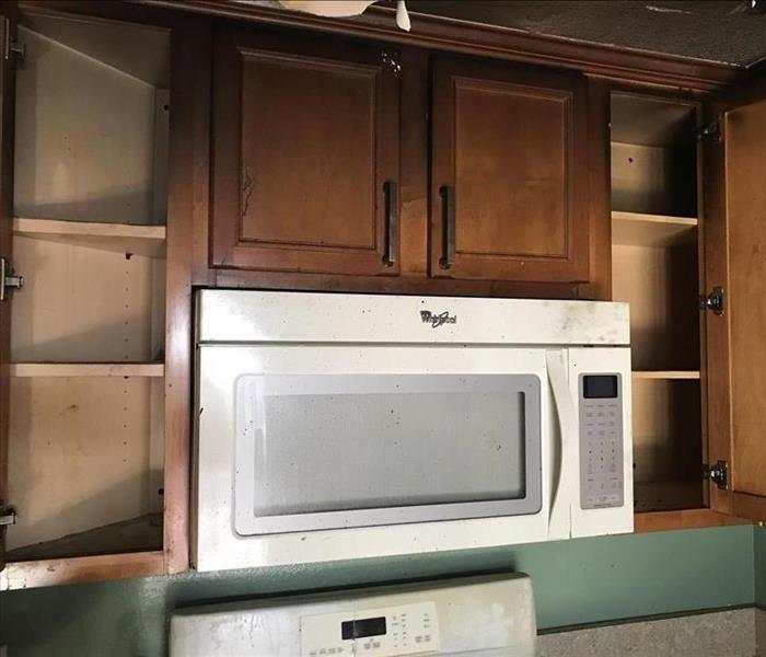 Empty kitchen cabinets show the end result of a contents pack out