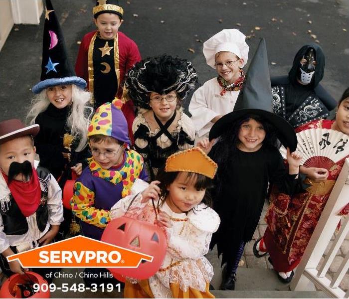 Children in costumes celebrate Halloween.